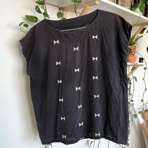 UZI NYC black boxy top with geometric bow print